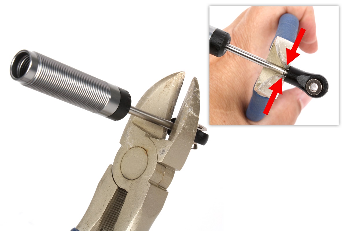 Grip the shaft just above the rod end