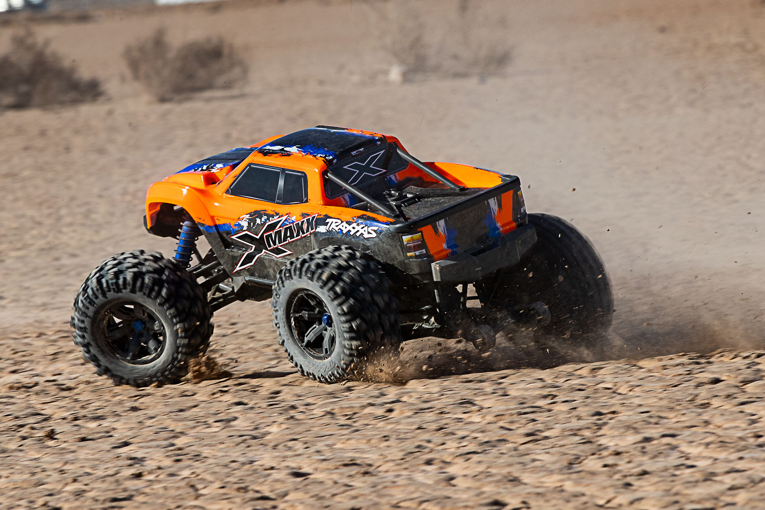 Orange X-Maxx sand dune side view
