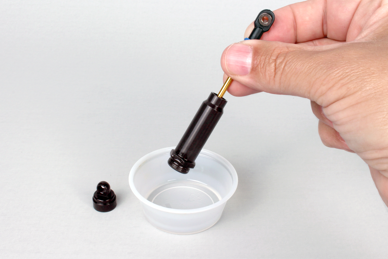 Drain the shock the oil into a disposable cup.