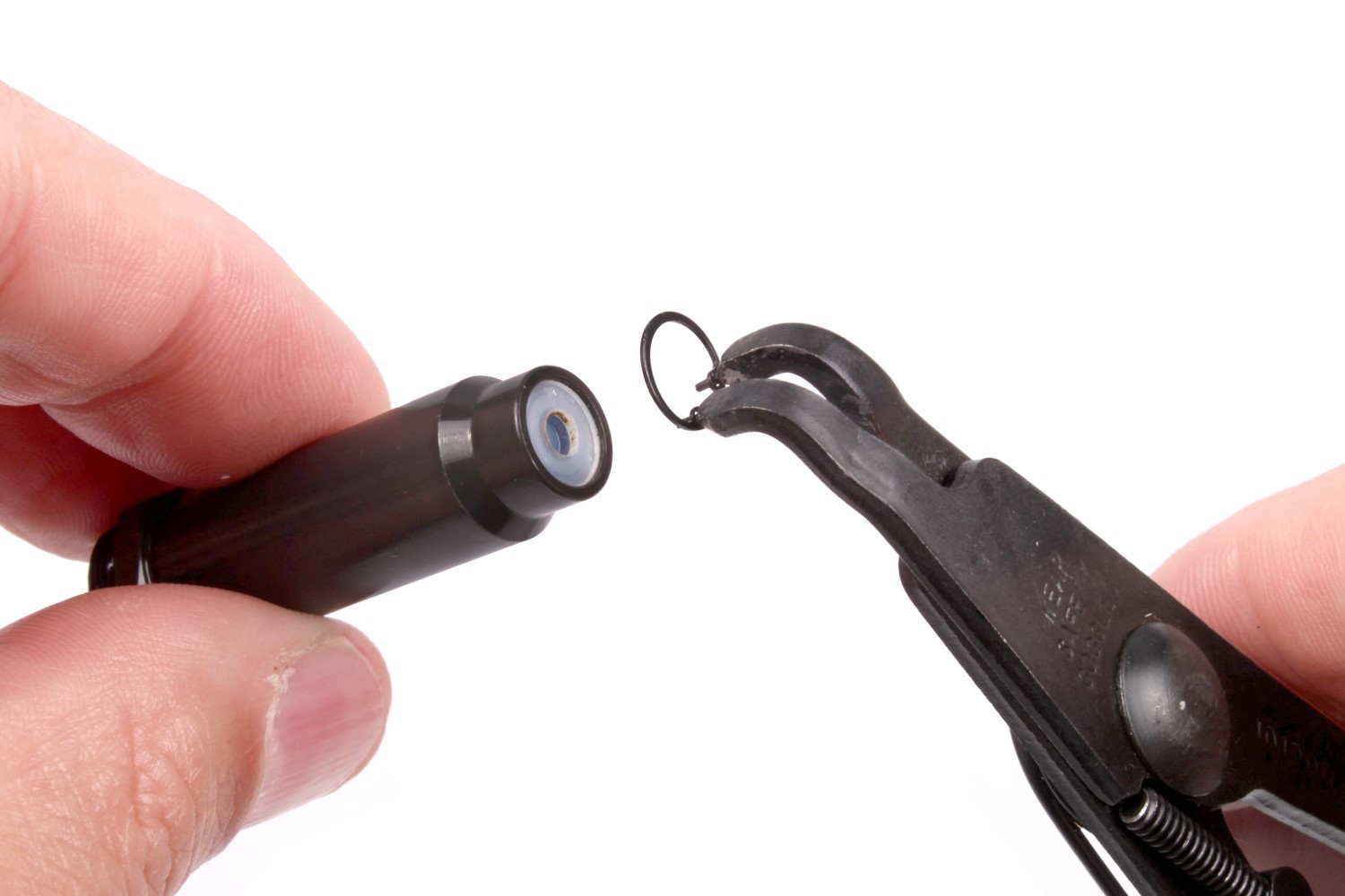 Squeeze the clip’s ends together, slide it out of the groove, and lift the clip out. 