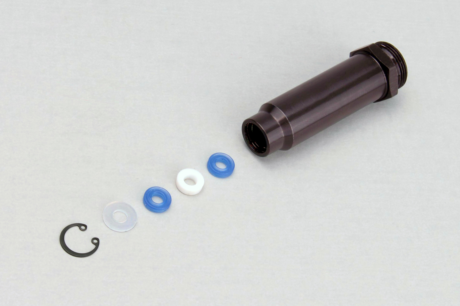 Install the seals, spacer, washer, and C-clip in this order.
